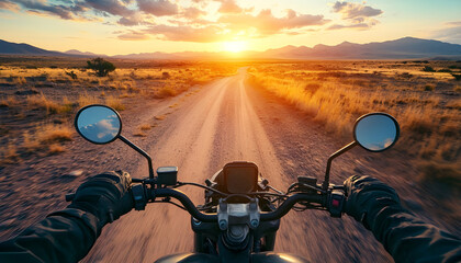 Motorcycle rider perspective on dirt road through desert landscape at sunrise. Experience adventure, freedom, and solitude on offroad journey across arid terrain, with handlebars and glove visible