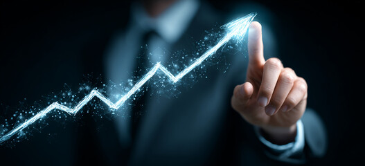 Businessman touching a glowing upward arrow graph symbolizing business growth, success, and financial progress

