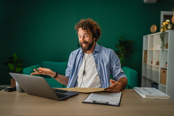 Freelancer having video call and explaining something to client from home office