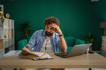 Stressed entrepreneur feeling frustrated while working at home office