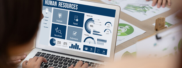 Human resources management software on computer screen helping human resources employee to manage...