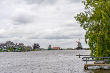 Rural landscape with windmill in Zaanse Schans. Holland, Netherlands. Authentic Zaandam mill. Beautiful Netherland landscape.