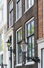 Details and facades of Amsterdam characteristic brick construction of residential building in Amsterdam School style. High quality photo