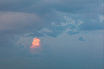 Golden Hour Sky. Evening cloudy sky with stunning light. Clouds illuminated by the setting sun. Incredibly beautiful sky with clouds.