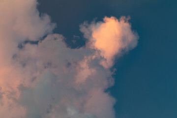 Golden Hour Sky. Evening cloudy sky with stunning light. Clouds illuminated by the setting sun. Incredibly beautiful sky with clouds.