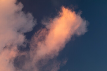 Golden Hour Sky. Evening cloudy sky with stunning light. Clouds illuminated by the setting sun. Incredibly beautiful sky with clouds.