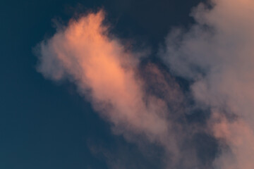 Golden Hour Sky. Evening cloudy sky with stunning light. Clouds illuminated by the setting sun. Incredibly beautiful sky with clouds.