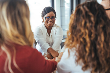 Diverse Team Completing a Trust-Building Activity Together in Modern Office