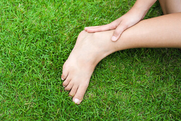 Ankle pain. Young woman suffering from ankle pain.