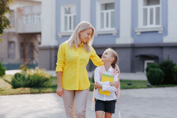 Mother and Daughter Walking to School on First Day, Back to School Family Education Concept