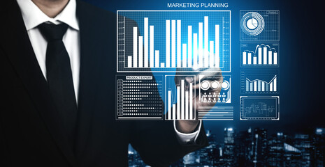 A business professional conducts data analysis and strategizes marketing planning using digital technology. Modern graphics and statistics enhance the visual appeal. Impute