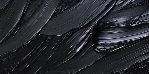 A close up of thick black paint strokes creating an abstract textured dark surface background image