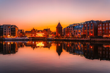 Fototapeta premium Gdansk with Motlawa river in Poland. Old town colourful house with Stragania Gate