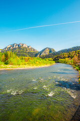 Peak Tri Koruny or Trzy Korony during day with green meadow and trees in spring. Pieniny National park in Slovakia and Poland