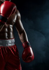 Powerful boxer with red gloves and shorts ready for fight