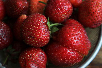 Strawberries in a sieve on a table