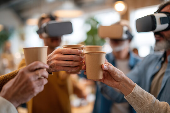 Coworkers engage in virtual reality experience while enjoying drinks together