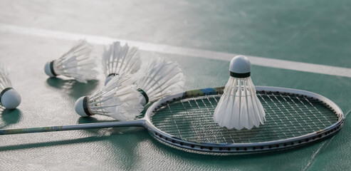 Badminton balls and badminton rackets on court