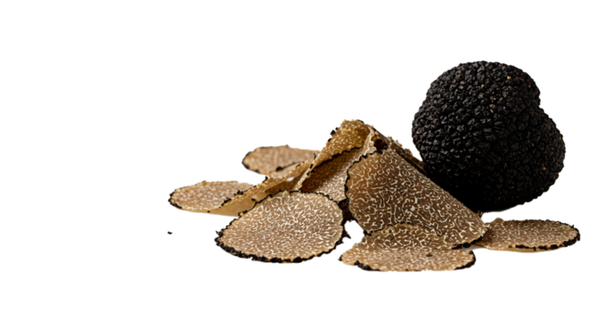 A whole black truffle and several truffle slices on a black background in a studio setting close up view on transparent background