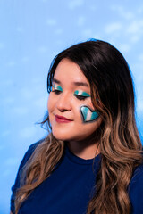 Female Portrait with Guatemalan Themed Makeup and Light Blue Background