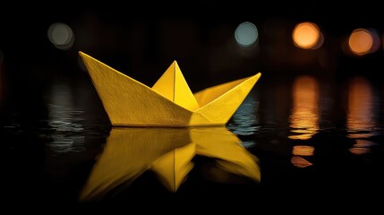 Small Yellow Paper Boat Floating on Dark Water at Night