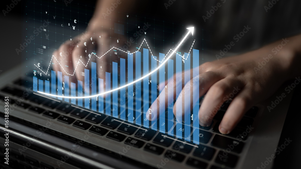 Poster close-up of hands working on a laptop keyboard with a digital financial graph overlay, illustrating 