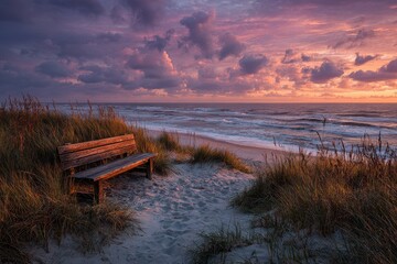 Morning sunlight over sandy path at beach, scenic ocean waves and coastal grass under cloudy sunrise sky at coastline of Sylt, Germany