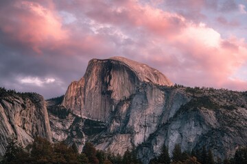 Mountain Half Dome at Yosemite National Park rock face with pinktinged clouds above