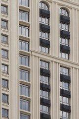 facade of the building is in a classic style with arched windows and balconies in bright colors