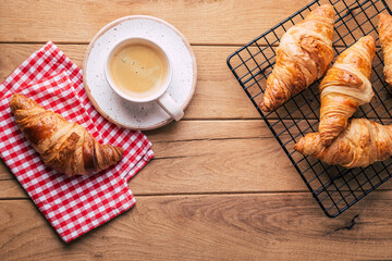 Croissants and coffee on a red checkered napkin