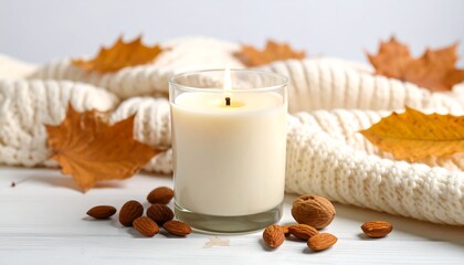 Cozy autumn candle scene on a white surface