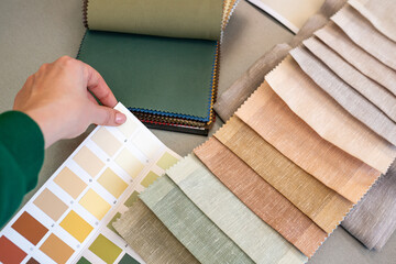 Top view of Interior designer choosing materials for home renovation. Woman matching samples the...