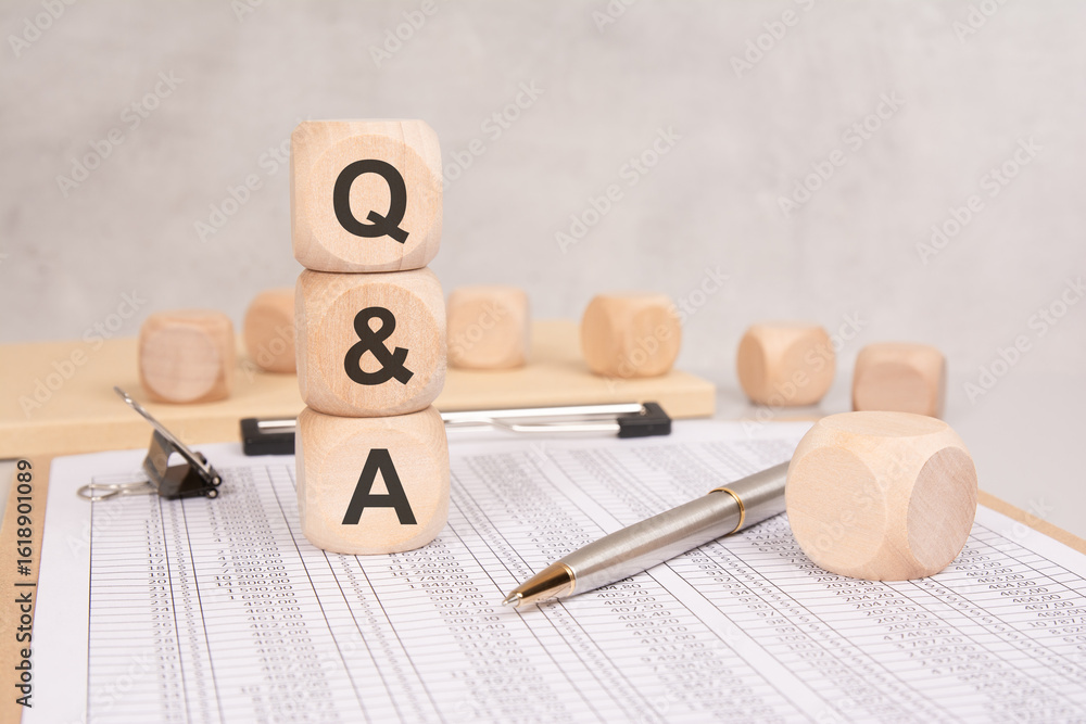 Poster wooden blocks with q and a on financial documents. questions and answers concept in business