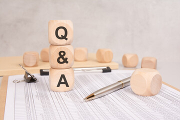 wooden blocks with Q and A on financial documents. questions and answers concept in business