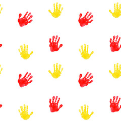 Seamless pattern of red and yellow children's handprints. Illustration of chilren's palms on white backgound. International Children's Day.