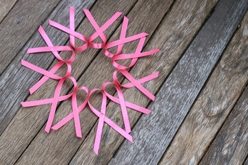 healthcare and medicine concept. pink breast cancer awareness ribbon on wood table.