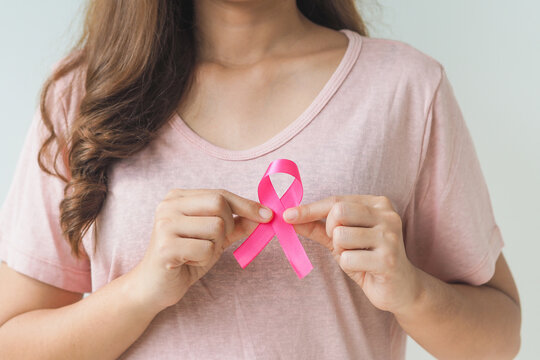 healthcare and medicine concept. Woman hand holding pink breast cancer awareness ribbon.