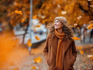 Young beautiful happy woman outdoors in autumn in the park dressed in warm clothes. Autumn fashion trends, active leisure, health promotion themes