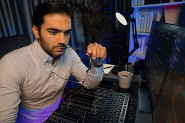 Working smart IT developer analyzing data software development on two pc screen, creating...
