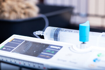 A syringe has been placed carefully on top of a control panel