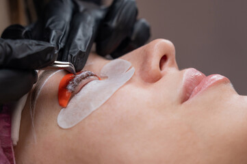 Caucasian woman undergoing eyelash lamination procedure. 