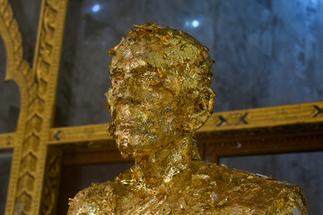 Stone statue covered in gold in Phuket.