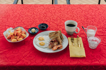 breakfast on a red tablecloth on the background of the ocean