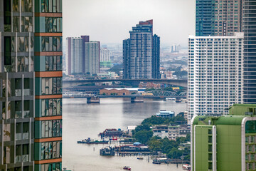Panoramic view of the modern city of Bangkok, Thailand, with the Chao Phraya River between the buildings