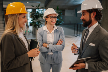 Architects and engineers having a meeting on construction site