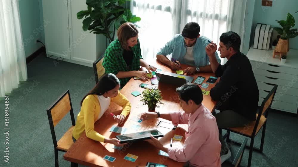 Aufkleber top view of business team writing sticky notes while manager working on tablet and looking at analys