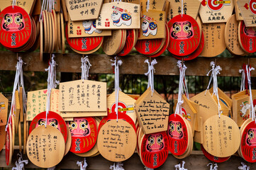 Colorful Japanese Ema Prayer Plaques and Daruma Wishes at a Shinto Shrine