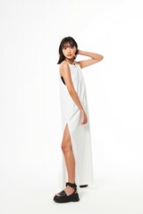 Young Woman in White Dress Posing Against White Background - Fashion Studio Shot