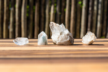 Collection of natural clear quartz crystals on a wooden surface