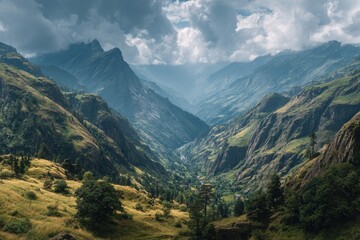 Naklejka premium Majestic mountains reach into a cloudy blue sky with misty valleys below in the range, a breathtaking and serene vista of nature's grandeur and mountain peaks covered in snow